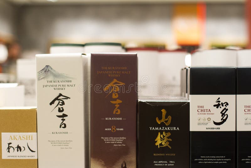 Bucharest, Romania - June 17, 2018: closeup of Japanese whisky bottles Kurayoshi, Chita, Yamazakura, and Akashi brands in packaging boxes with different flavors and label design standing on supermarket shelves. Bucharest, Romania - June 17, 2018: closeup of Japanese whisky bottles Kurayoshi, Chita, Yamazakura, and Akashi brands in packaging boxes with different flavors and label design standing on supermarket shelves