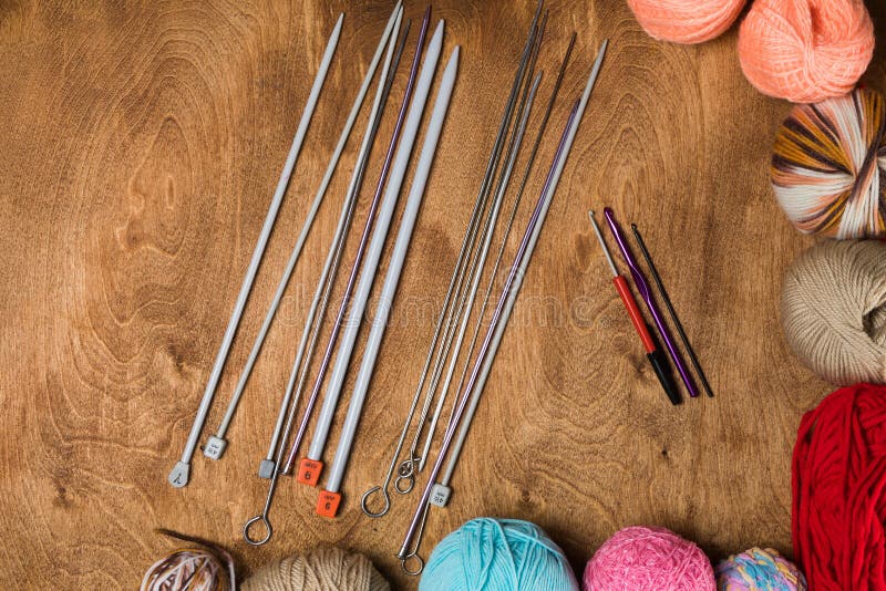 Closeup Of Knitting Needles With Balls Of Yarn In Different Colors
