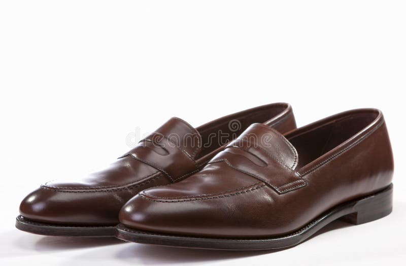 Closeup of Leather Stylish Brown Penny Loafer Shoes Together Against White Background