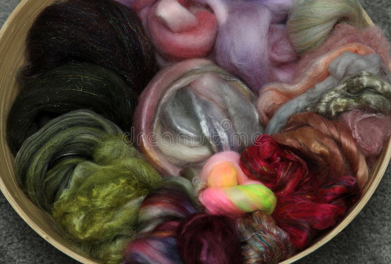 Closeup of lots of beautiful sheep wool fibres rolled up in a roving ready for spinning yarn on a spinning wheel as a hobby. Closeup of lots of beautiful sheep wool fibres rolled up in a roving ready for spinning yarn on a spinning wheel as a hobby