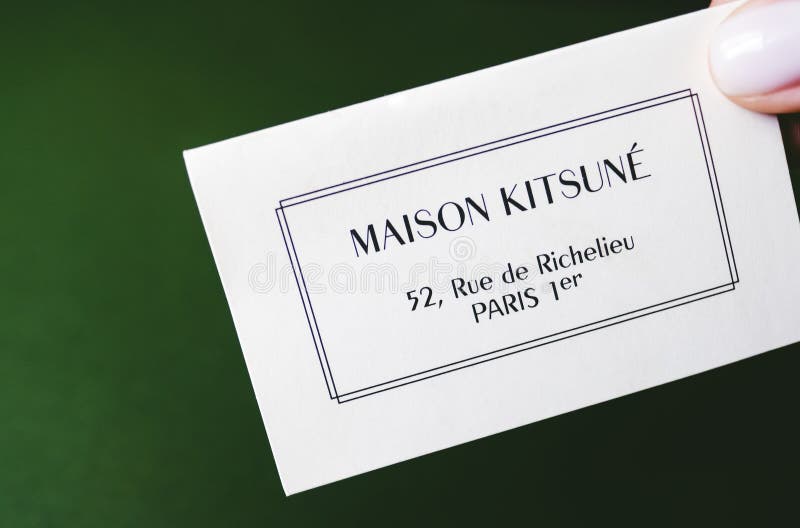 Closeup of Maison Kitsune Logo Label on Green Background Editorial