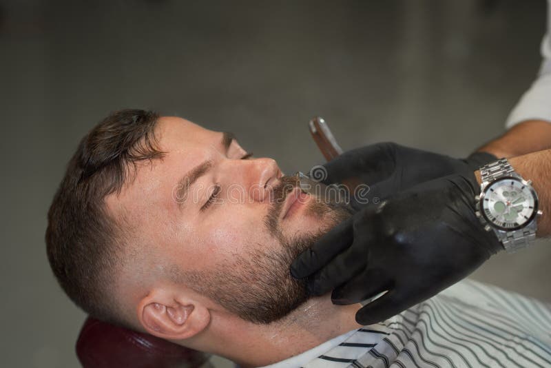 Closeup of male client during shaving in barber shop royalty free stock photo Closeup of male client during shaving in barber shop royalty free stock photo