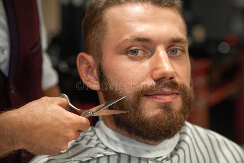 Closeup of man getting styling of beard in barber shop royalty free stock photos Closeup of man getting styling of beard in barber shop royalty free stock photos