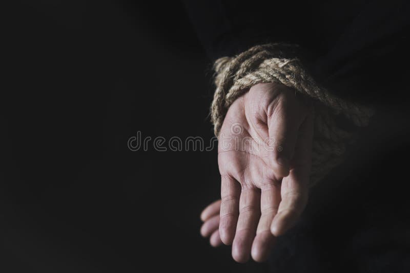 Man with his hands tied behind his back