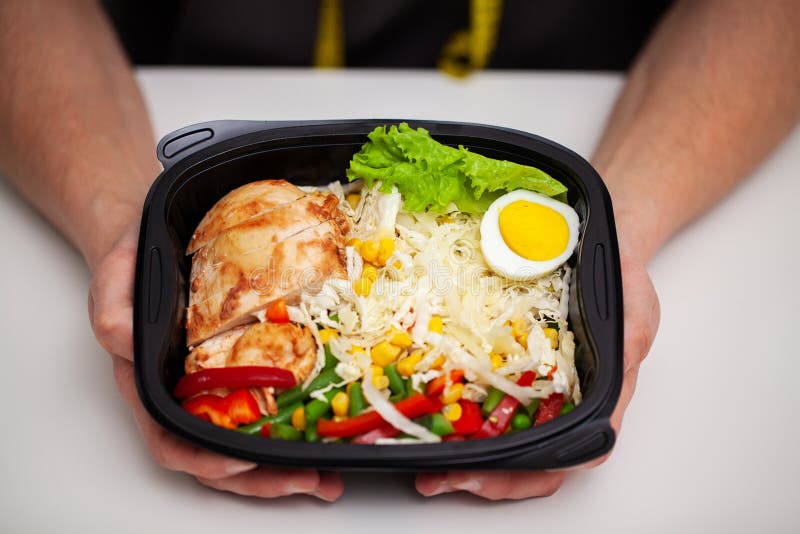 Closeup of a man holding a box full of protein rich foods for sports nutrition royalty free stock photos Closeup of a man holding a box full of protein rich foods for sports nutrition royalty free stock photos