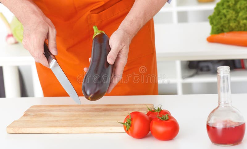 Closeup man`s hands cutting vegetables on a work surface in a kitchen. Dieting concept. royalty free stock photo Closeup man`s hands cutting vegetables on a work surface in a kitchen. Dieting concept. royalty free stock photo