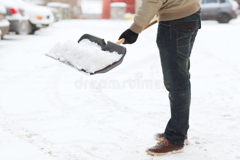 Closeup of man shoveling snow from driveway stock images Closeup of man shoveling snow from driveway stock images
