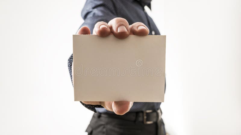 Closeup of a man showing a blank white business card stock images