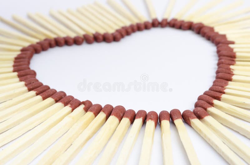 Closeup of match sticks arranged to form a heart shape