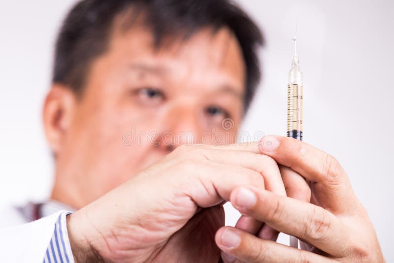 Closeup of medical doctor hand holding syringe for injection stock images Closeup of medical doctor hand holding syringe for injection stock images