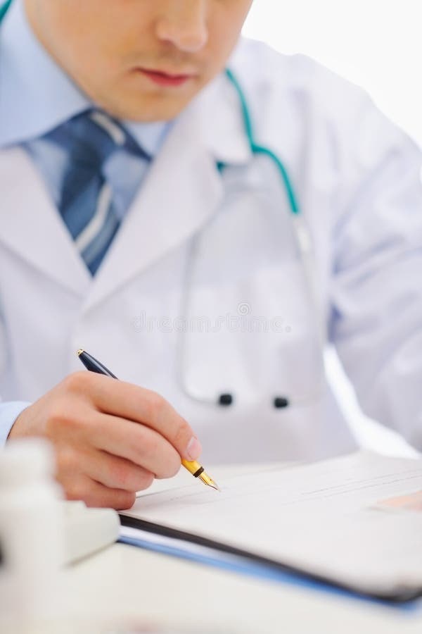 Closeup of medical doctor working with documents royalty free stock photography