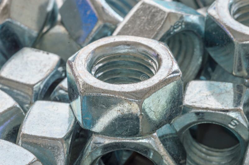 Closeup on Metal Nut. Nut is a Type of Fastener with a Threaded Hole