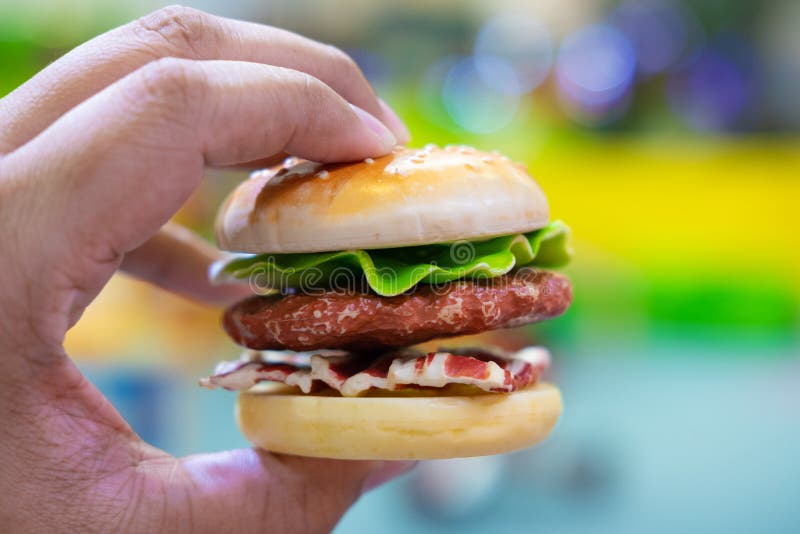 Closeup Of Mini Plastic Hamburger Toy With Blurred Background. Stock