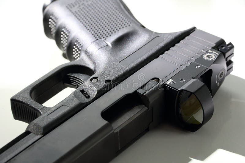 Closeup of 9 mm pistol on a white background. Handgun with a red dot sight. Glock 19.