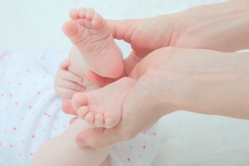 Mother Hands Holding Baby Feet royalty free stock photos