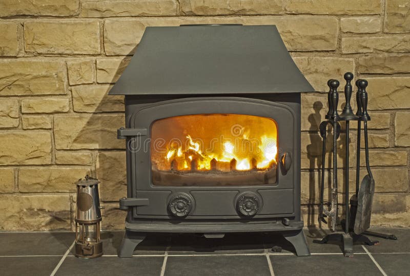 Closeup of multi fuel burner stove fire with hearth stock photos Closeup of multi fuel burner stove fire with hearth stock photos