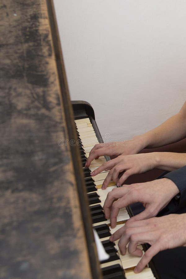Closeup of Musician Hands Playing on Yellow Piano`s Keys with Bright