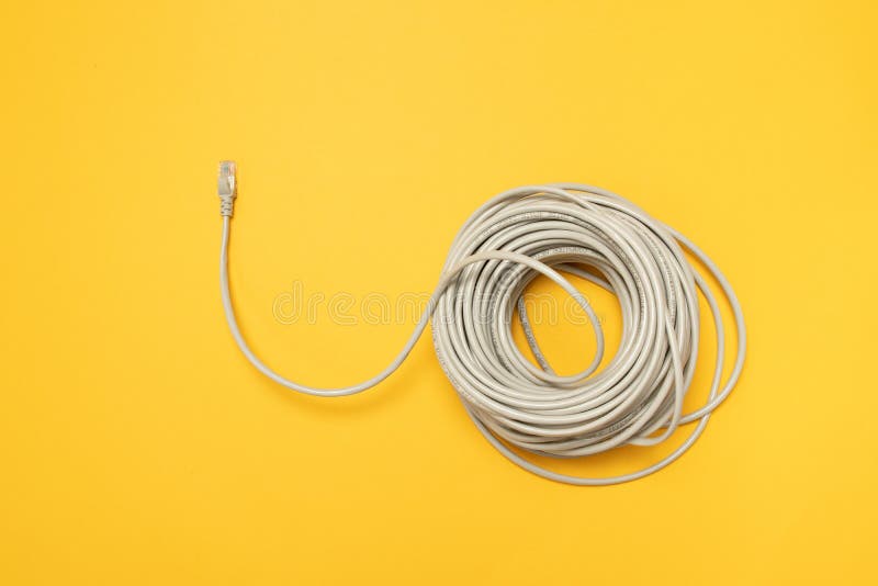 Closeup RJ45 Network internet cable hank on a yellow background. Concept, flat lay