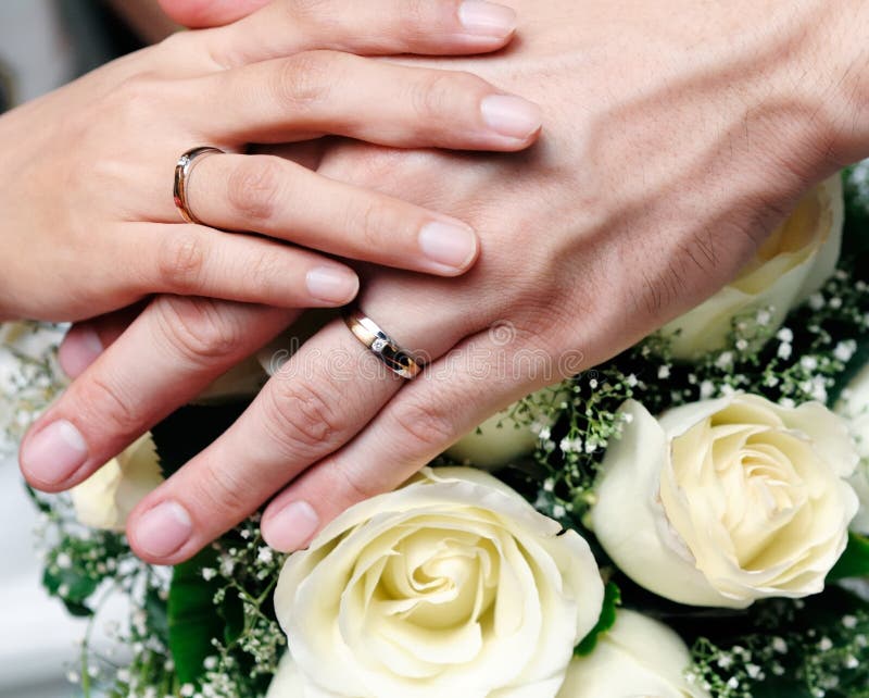 Closeup of newlywed couple holding hands stock image Closeup of newlywed couple holding hands stock image