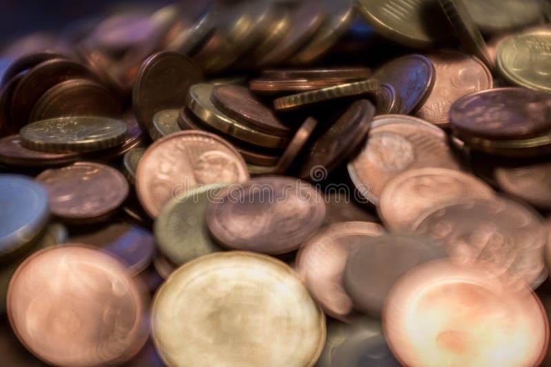 Closeup of old coins on the table under light with a blurry background. Circle, isolated.