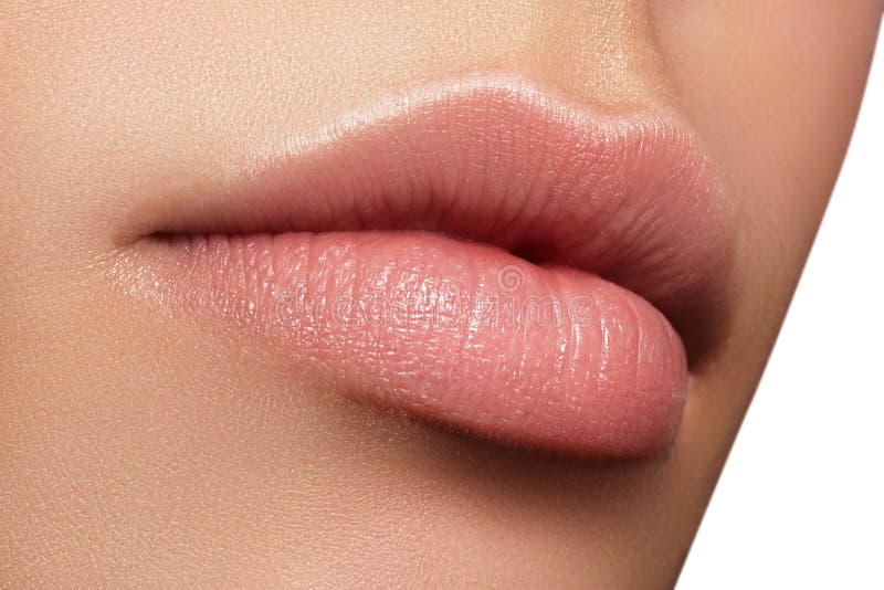 Closeup perfect natural lip makeup. Beautiful plump full lips on female face. Clean skin, fresh make-up. Spa tender lips