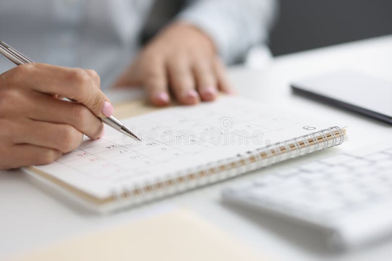 Closeup of Person Marking with Pen and Looking at Date on Calendar ...