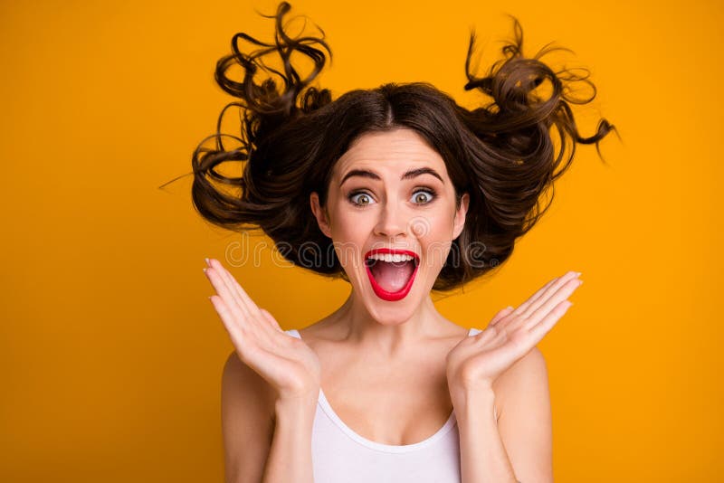 Closeup photo of funny crazy lady cheerful good mood open mouth arms near cheekbones hairstyle flight wear white casual stock photography