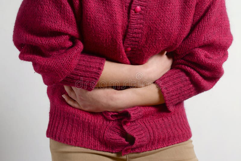 Closeup photo. a woman has a pain in her stomach, and holds her hands. Concept of female medicine. Digestive problems, gynecology royalty free stock photography Closeup photo. a woman has a pain in her stomach, and holds her hands. Concept of female medicine. Digestive problems, gynecology royalty free stock photography