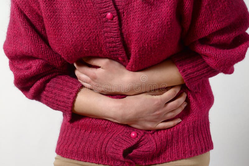 Closeup photo. a woman has a pain in her stomach, and holds her hands. Concept of female medicine. Digestive problems, gynecology royalty free stock image Closeup photo. a woman has a pain in her stomach, and holds her hands. Concept of female medicine. Digestive problems, gynecology royalty free stock image