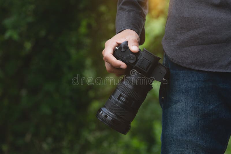 Closeup on photographer hand holding camera