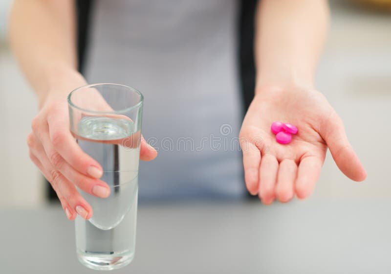 Closeup on pills in hand of young housewife royalty free stock photography Closeup on pills in hand of young housewife royalty free stock photography