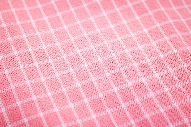 Closeup of pink tablecloth background. Detail of fabric in picnic pattern stock image
