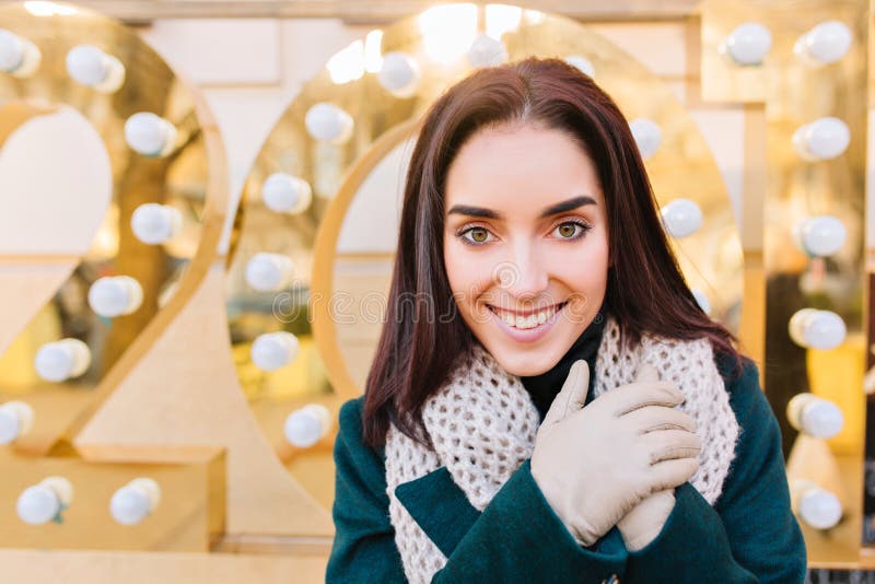 Closeup portrait of cheerful fashionable young woman with cut brunette hair celebrating new year 2017 on street. Stylish royalty free stock images Closeup portrait of cheerful fashionable young woman with cut brunette hair celebrating new year 2017 on street. Stylish royalty free stock images