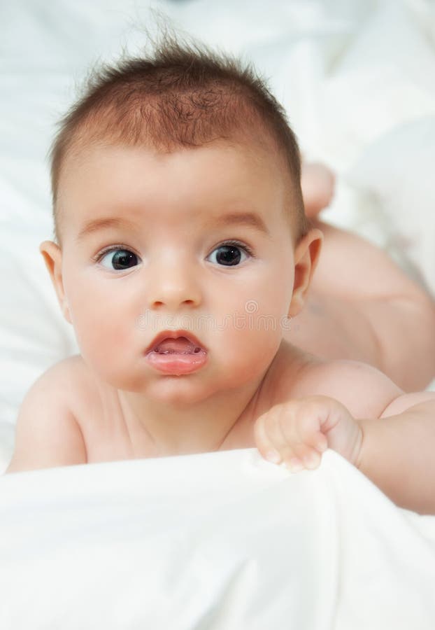 Closeup portrait of cute smiling baby boy