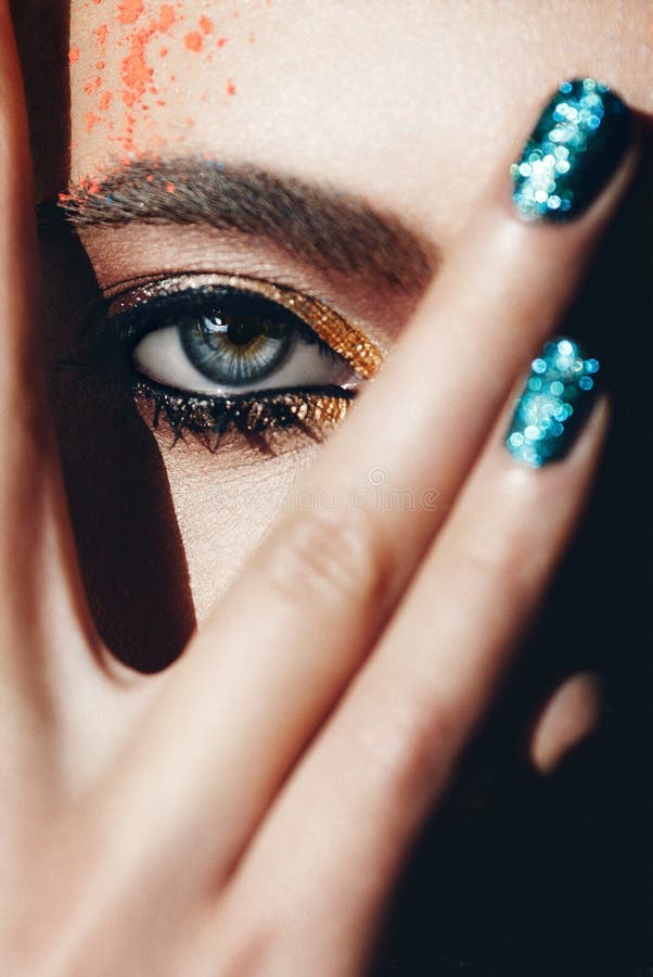 Closeup Portrait with Deep Blue Eye, Creative Makeup and Hand Stock