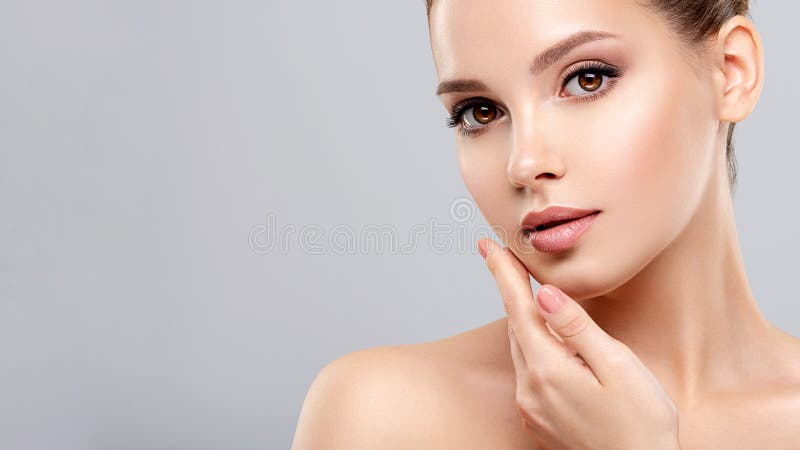 Closeup portrait of a  face of the young pretty girl with a healthy skin. Beautiful face of young white woman with a clean skin.