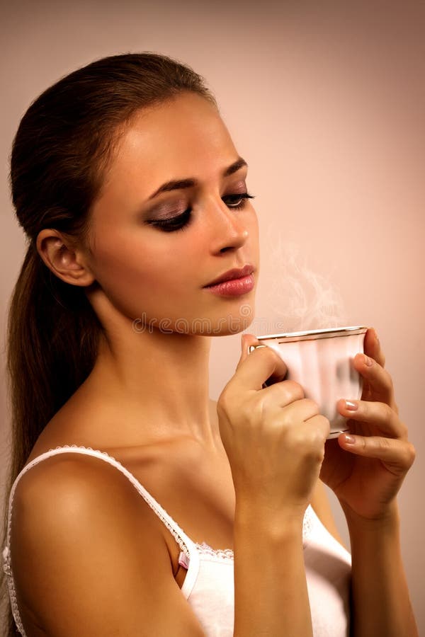 Closeup portrait of girl with a cup of coffee