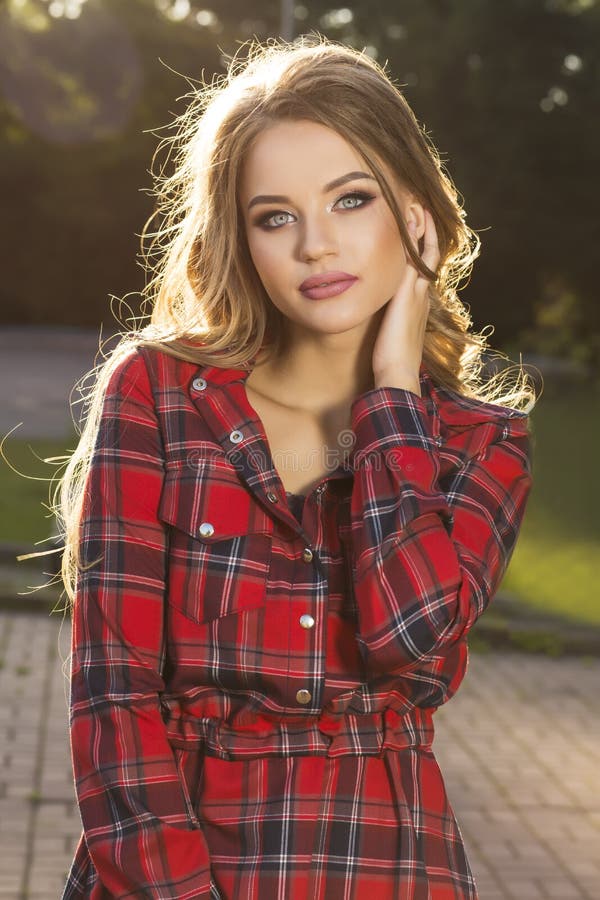 Closeup portrait of gorgeous blonde model in trendy dress posing