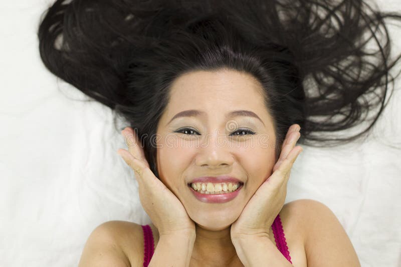 Closeup portrait of happy asian women lying on ground with black long hair. acting smile, fun stock photography Closeup portrait of happy asian women lying on ground with black long hair. acting smile, fun stock photography