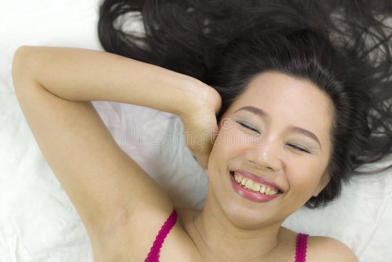 Closeup portrait of happy asian women lying on ground with black long hair. acting smile, fun stock images Closeup portrait of happy asian women lying on ground with black long hair. acting smile, fun stock images