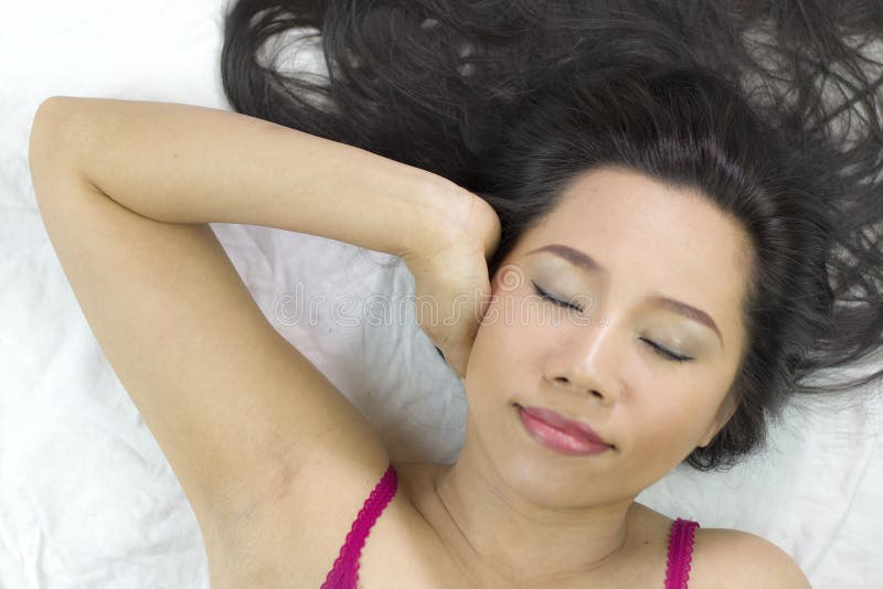 Closeup portrait of happy asian women lying on ground with black long hair. acting smile, fun stock photo Closeup portrait of happy asian women lying on ground with black long hair. acting smile, fun stock photo