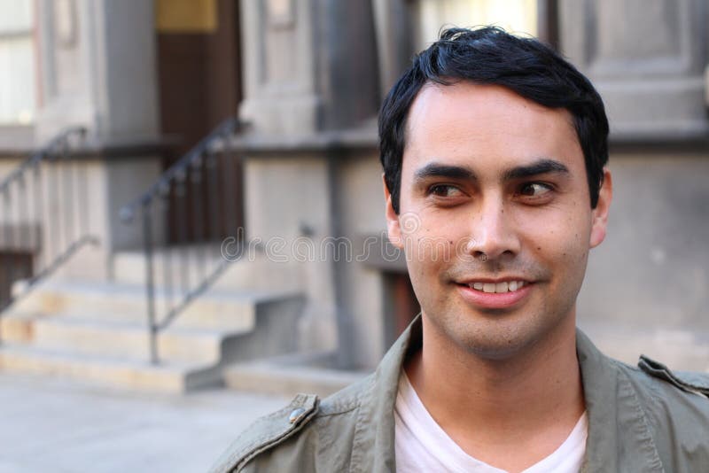 Closeup portrait of a happy Hispanic/Spanish man looking to left. Against urban background stock photos Closeup portrait of a happy Hispanic/Spanish man looking to left. Against urban background stock photos