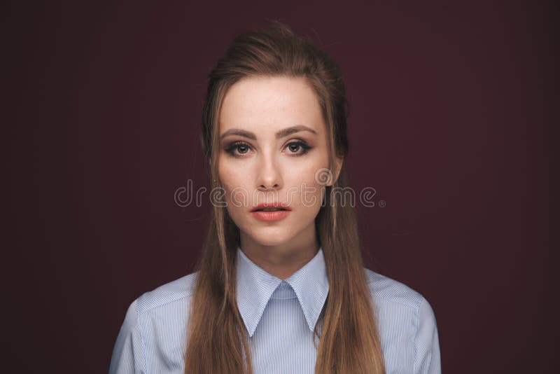 Closeup portrait of pretty yong woman with bright makeup in a studio isolated over dark pink background. stock photo Closeup portrait of pretty yong woman with bright makeup in a studio isolated over dark pink background. stock photo