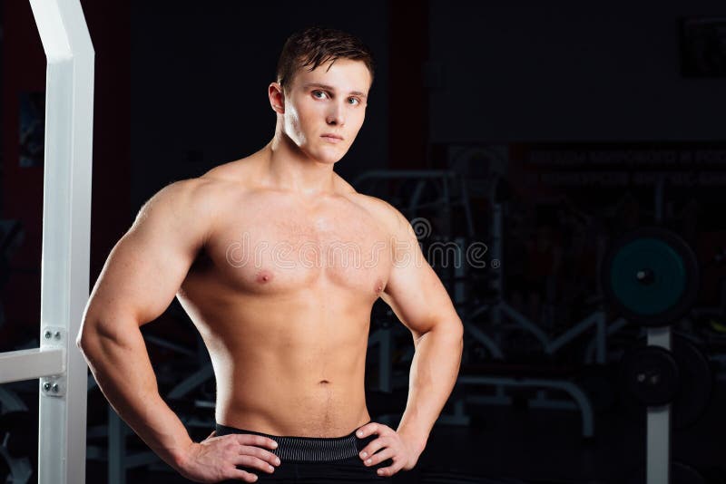 Closeup portrait of professional bodybuilder workout with barbell at gym. Confident muscular man training . Looking at camera. Motivation