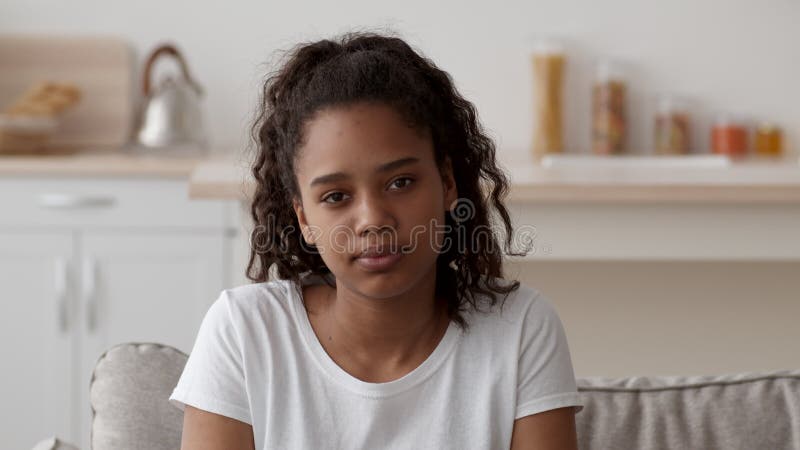 Closeup Portrait Of Sad African American Teen Girl Looking At Camera