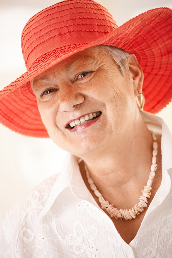 Closeup portrait of senior woman wearing hat