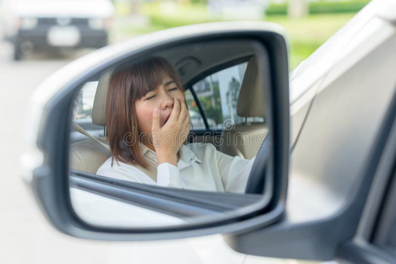 Closeup portrait sleepy, tired young woman driving her car after