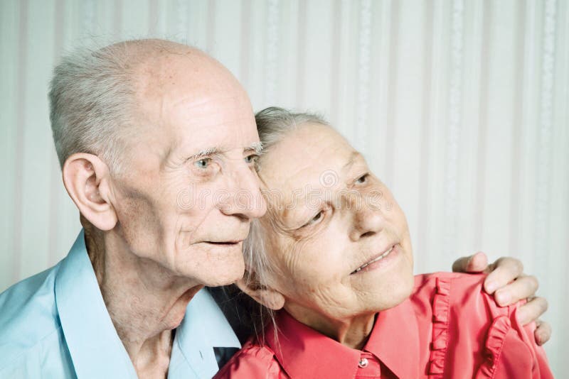 Closeup portrait of smiling elderly couple