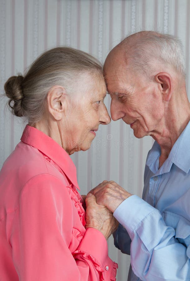 Closeup portrait of smiling elderly couple