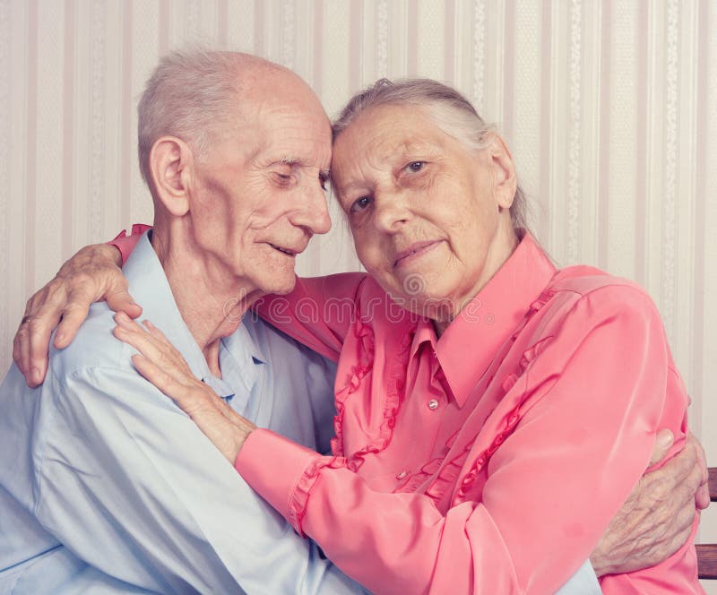 Closeup portrait of smiling elderly couple